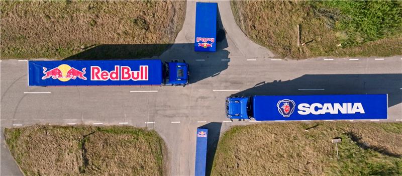 Matt Jones, has less than one second to jump through two trailers being pulled by moving Scania trucks