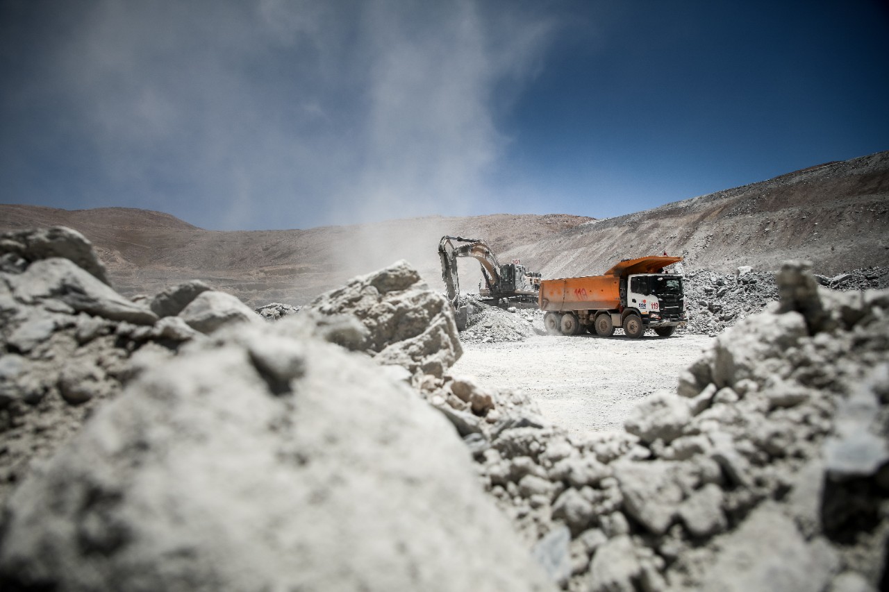 Un hombre con casco de seguridad inspeccionando un vehículo Scania