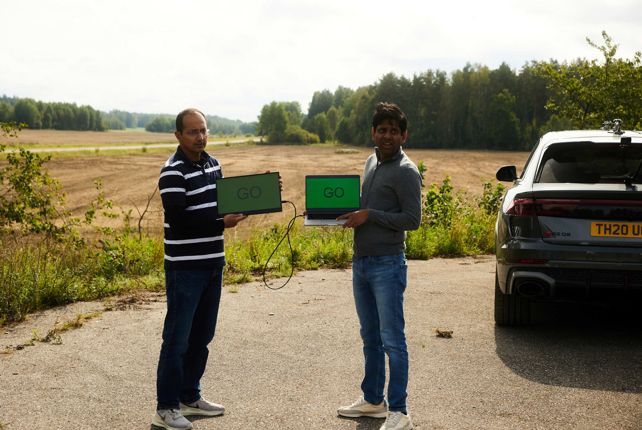 Scania colleagues with GO signs