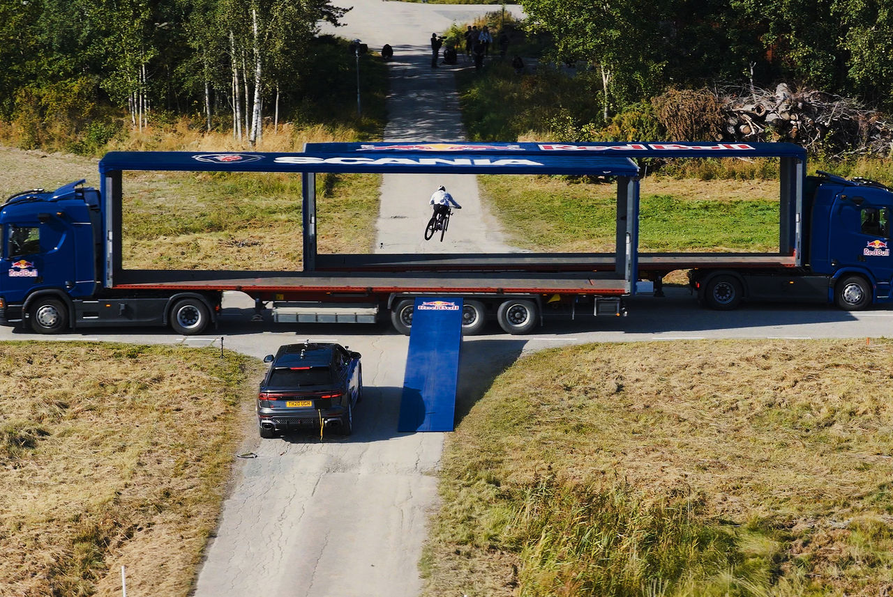 Matt Jones jumping through two trailers on bike