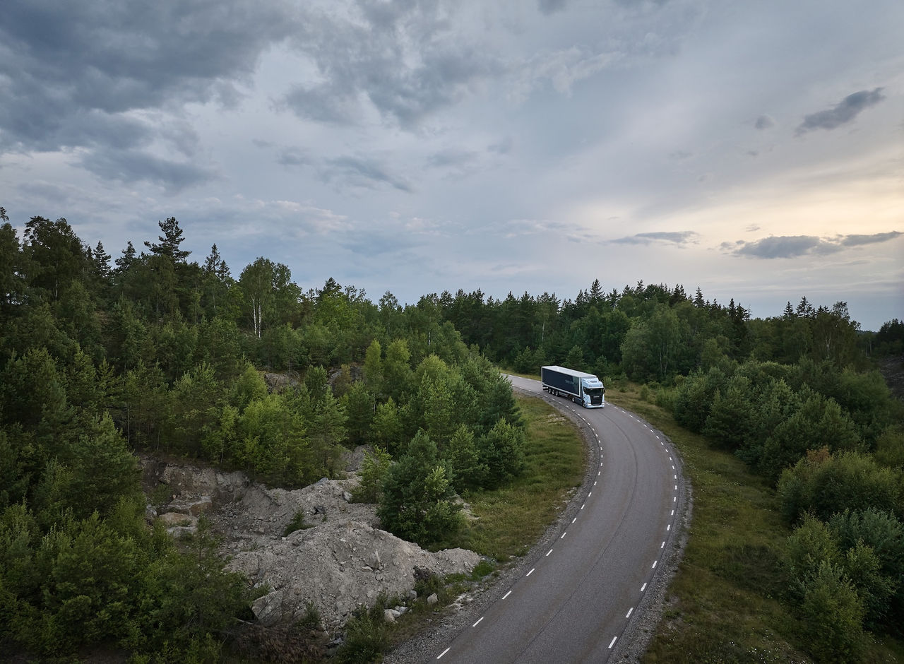Truck on a road with green forest around