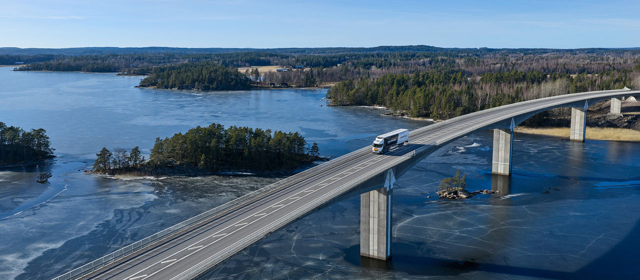 Truck on a bridge above icy water