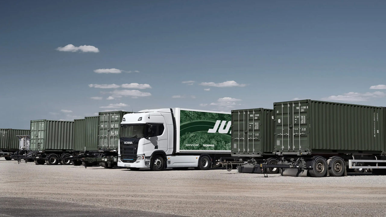 A parked Scania truck with the JUNA logo on the trailer.