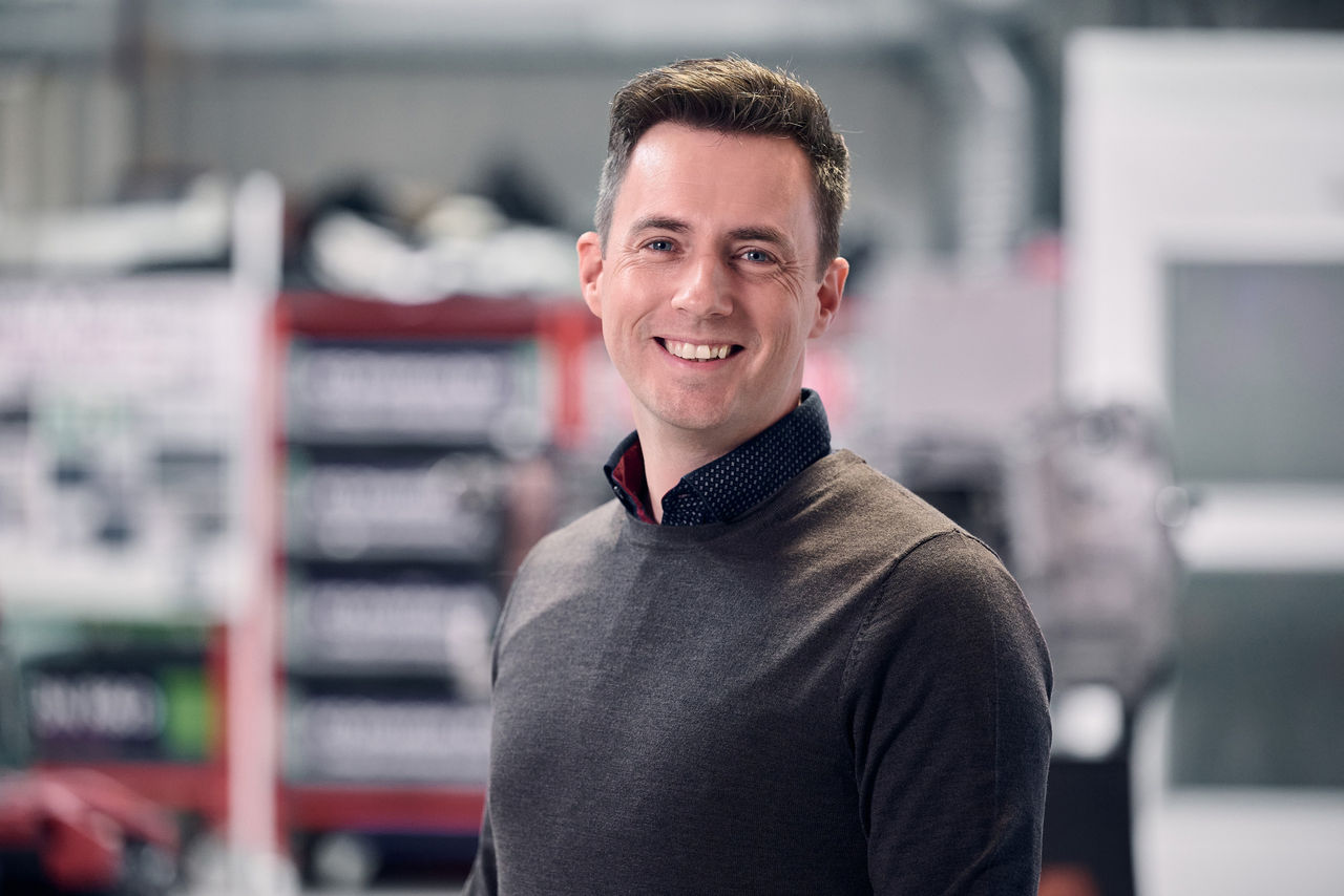 A portrait of  a smiling Per Arnelöf, System Architect at Scania ePropulsion & Drivertrain.